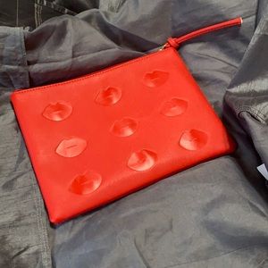 Lord & Taylor clutch with 👄 detailing on front